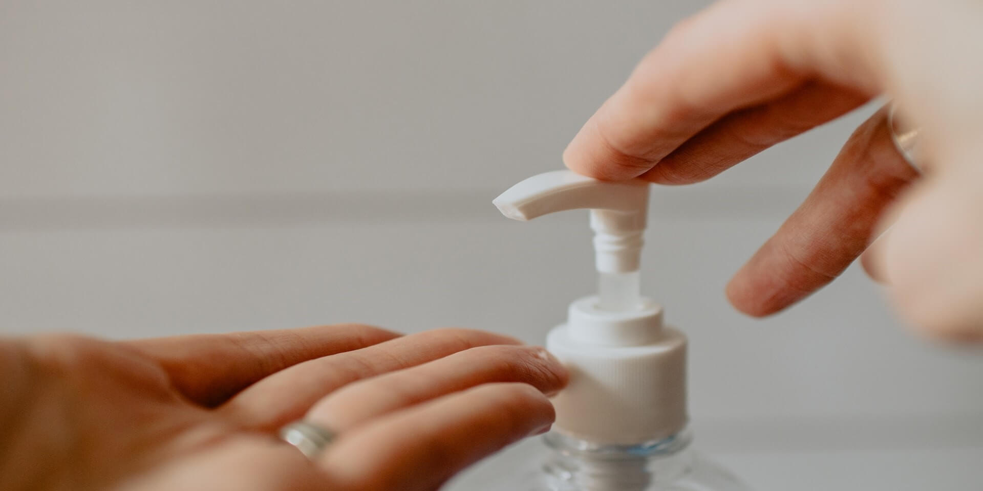 hand sanitizer close up of someone putting hand sanitizer on their hands