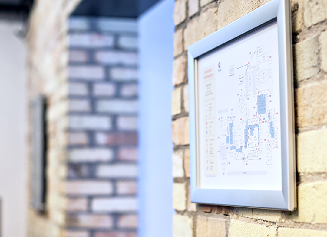 fire evacuation map on brick wall