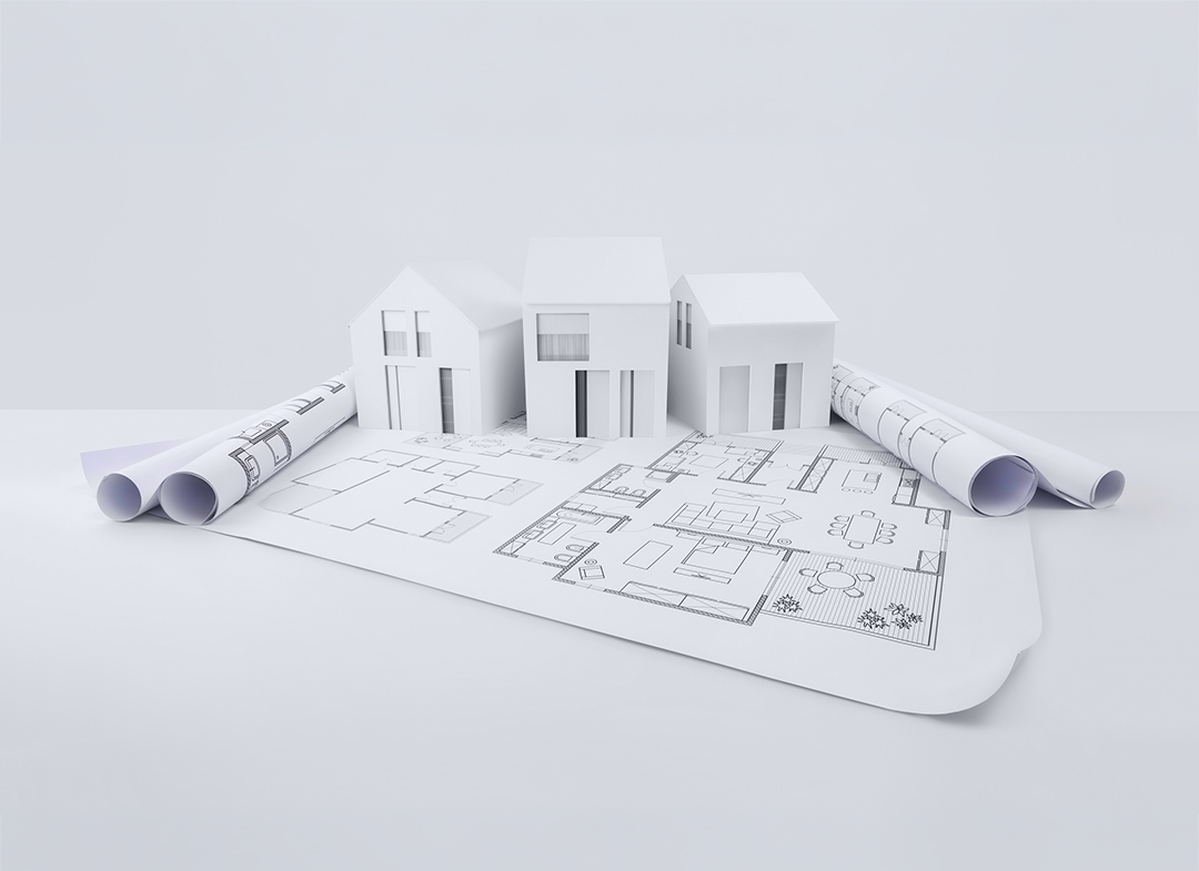 architectural model of houses on blueprint draw, isolated on white background, banner layout with copy space for building construction plan or real estate sale, Image usable for concept of bank loan